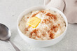 rice pudding with butter cinnamon. french riz au lait, norwegian risgrot, traditional breakfast dessert