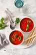 tomato and bell pepper vegetarian soup on green background