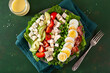 healthy American Cobb salad with egg bacon avocado chicken tomato. hearty keto low carb diet