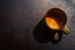 An espresso coffee shot on rustic table background.