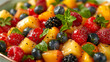 close - up of exotic fruit salad with mint garnish in a bowl