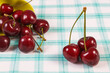 Fresh ripe cherries on checkered fabric. Healthy dessert or snack