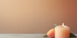 Peach background with white thin wax candle with a small lit flame for funeral grief death dead sad emotion with copy space texture for display 