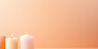 Peach background with white thin wax candle with a small lit flame for funeral grief death dead sad emotion with copy space texture for display 