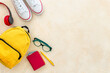Student yellow backpack with sneakers, flatlay, top view