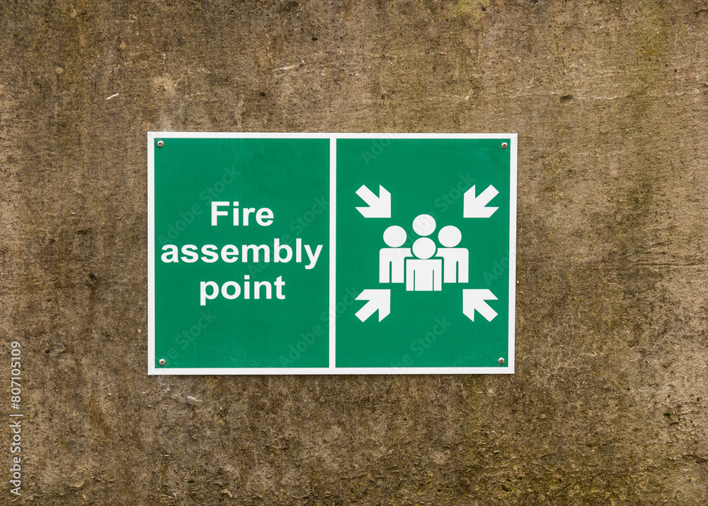Fire assembly point sign on a wall Stock Photo | Adobe Stock