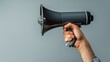 © Paul - Close-up of an actor's hand gripping a megaphone, conveying intent and passion, isolated against a plain background, studio-lit