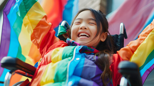 Happy young disabled asian girl in wheelchair with rainbow outfit during pride month celebrations. Child with mobility disability celebrating gay pride festival parade. Diverse equality  AI