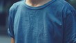© lovetnihouse - Close up of a young man wearing a blue t-shirt.