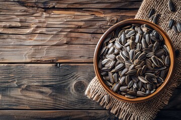 Wall Mural - Sunflower seeds in wooden bowl