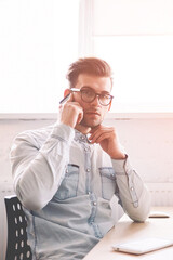 Poster - Confident male programmer talking with operator for checking account balance looking at camera while sitting indoors with computer with blank screen for your internet advertising on background