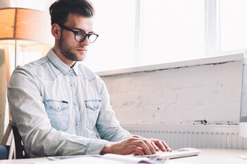 Poster - Serious male software developer keyboarding program code on modern computer sitting at office desktop, caucasian skilled man working with PC computer in coworking. School courses of digital marketing