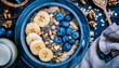 Healthy oatmeal bowl with banana blueberry walnut chia seeds and almond milk for breakfast or lunch with a top view