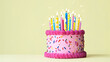 Pink celebration birthday cake with colorful birthday candles