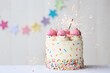 Birthday cake with colorful sprinkles and celebration sparklers