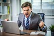© Alexander - Angry businessman sitting at his desk and screaming.