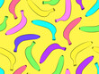 Seamless pattern with colorful bananas on a yellow background. Exotic multi-colored bananas in the style of the 80s. Design for posters, wrapping paper and wallpapers. Vector illustration