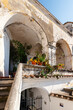 A courtyard in the Italian village of Albori. Stairs to the balcony with arches
