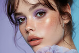 Fototapeta Góry - A detailed view of a females face featuring vibrant purple makeup accentuating her features