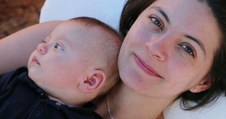 Wall Mural - Happy mother and baby son together looking to camera smiling