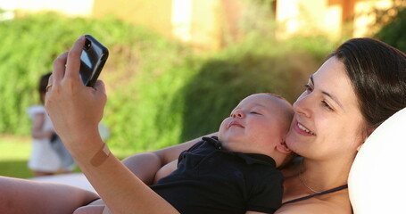 Wall Mural - Mother taking selfie with her baby infant son