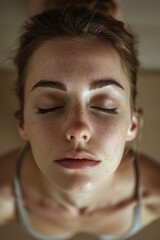 Wall Mural - Close-up of a woman with her eyes closed, suitable for relaxation or meditation concepts