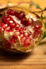 Wall Mural - Pomegranate, a beautiful pomegranate on rustic wood, selective focus.