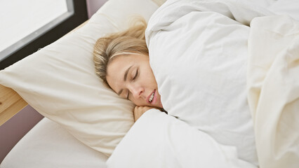 Poster - A tranquil young woman sleeps soundly in an indoor bedroom, evoking a peaceful and comfortable atmosphere.