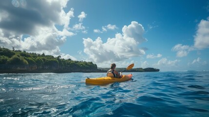 Wall Mural - A person in a kayak energetically paddling through the water on a sunny day.