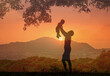 Father playing with his son child in a summer nature outdoor field. Family, trust, protecting, care, parenting concept