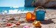 © YuDwi Studio - plastic сhildren's beach toys and a starfish on sand near sea. Summer vacation concept