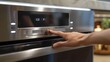 © Paul - Hand setting the microwave to defrost mode, captured in high detail on a modern kitchen appliance, emphasizing user-friendliness