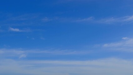 Wall Mural - blue sky with fluffy cloud time lapse on a sunny day 4k footage.