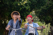 © Sophon_Nawit - Asian preteen boys riding bikes around their community park in the afternoon during their summer holiday together, recreational activity of children concept.