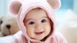 © Balaraw - Adorable baby girl in pink bear hoodie