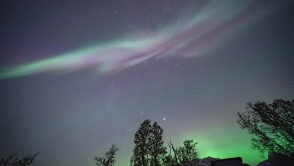 Wall Mural - Mesmerizing dance of the northern lights in the dark starry sky.