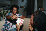 Fototapeta  - Excited man pulling card from hands of girlfriend