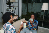 Fototapeta  - Cheerful Black couple enjoying playing cards at home after work