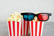 Popcorn, 3D glasses for cinema time on grey background. 
