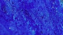 Wet Glitter Texture. Sparkling Fluid Wave. Defocused Blue Color Glowing Shimmering Liquid Ink Flow Motion Abstract Art Background.