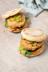 Wall Mural - two salmon fishburgers with pickles on top
