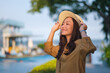 Portrait image of a beautiful young asian woman holding hat and relaxing in the resort