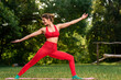 © Denys Kurbatov - Beautiful woman in sportswear training outdoor and standing in yoga warrior pose, Alone with nature: A young woman immerses in yoga stretches in the peaceful outdoor summer park
