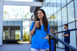Confident nurse on her way to work in a clinic.  Pretty female nurse drinking coffee and rest after hard work. The young adult female nurse drinks her coffee as she arrives to work at the hospital.