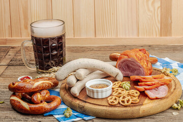 Wall Mural - Traditional Oktoberfest set. Pretzels, beer, weisswurst, eisbein with mustard. German festival food