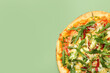 Delicious vegetarian pizza on green table, top view. Space for text