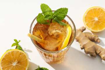 Wall Mural - Cold tea with ice, orange slices and mint leaves and ginger