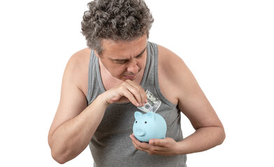 Wall Mural - A gray-haired, shaggy, unshaven middle-aged man in a sleeveless T-shirt holds a piggy bank and a 100 US dollar bill in his hands.