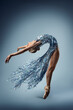 Ballerina Dance in Fantasy Silver Dress. Ballet Dancer bending Back backwards. Beautiful Girl in Ballerina Shoes stretching in Creative Tinsel Gown flowing in Air