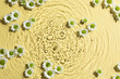 Beautiful chrysanthemum flowers in water on pale yellow background, top view